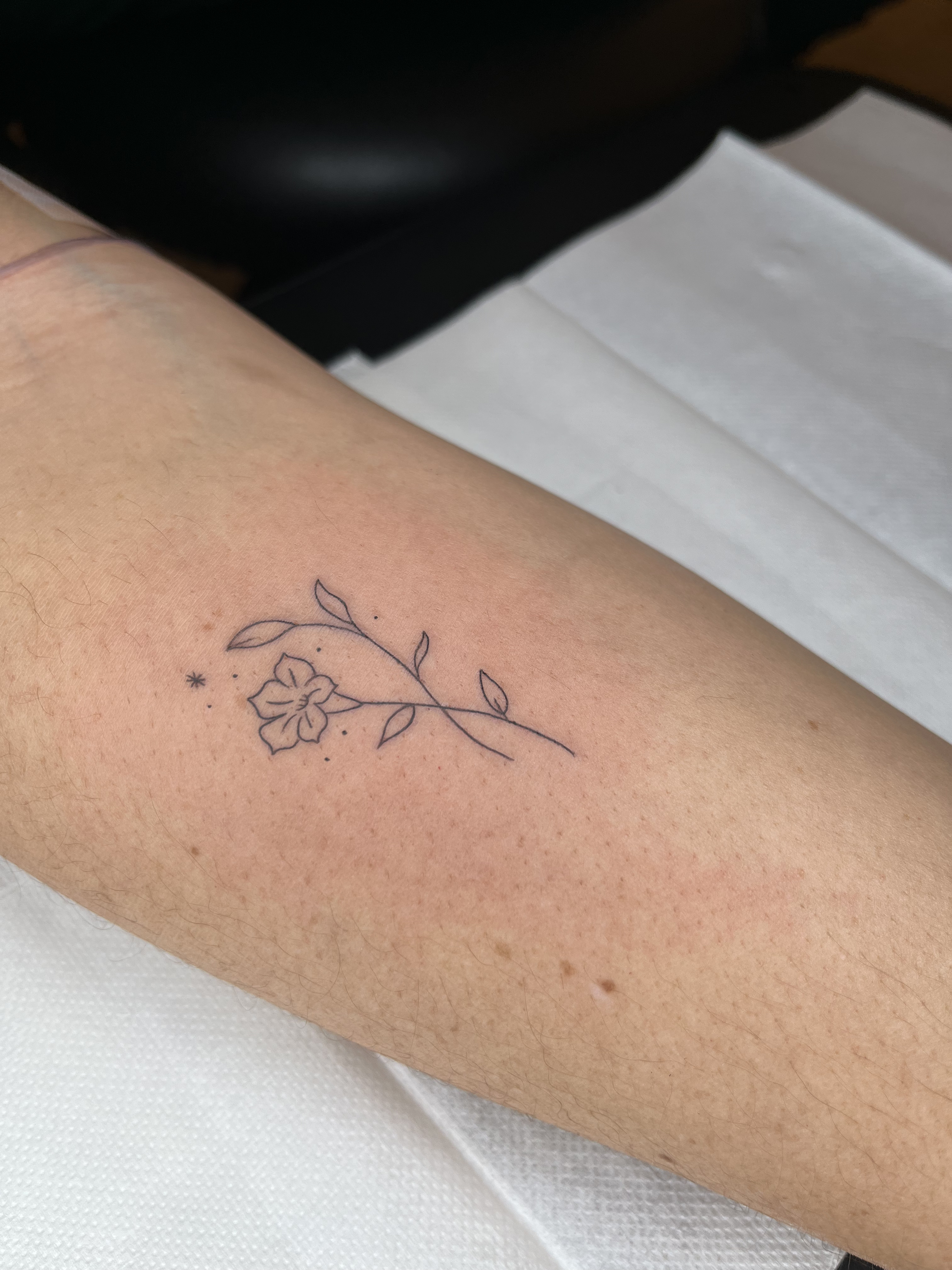 Fine line flower tattoo