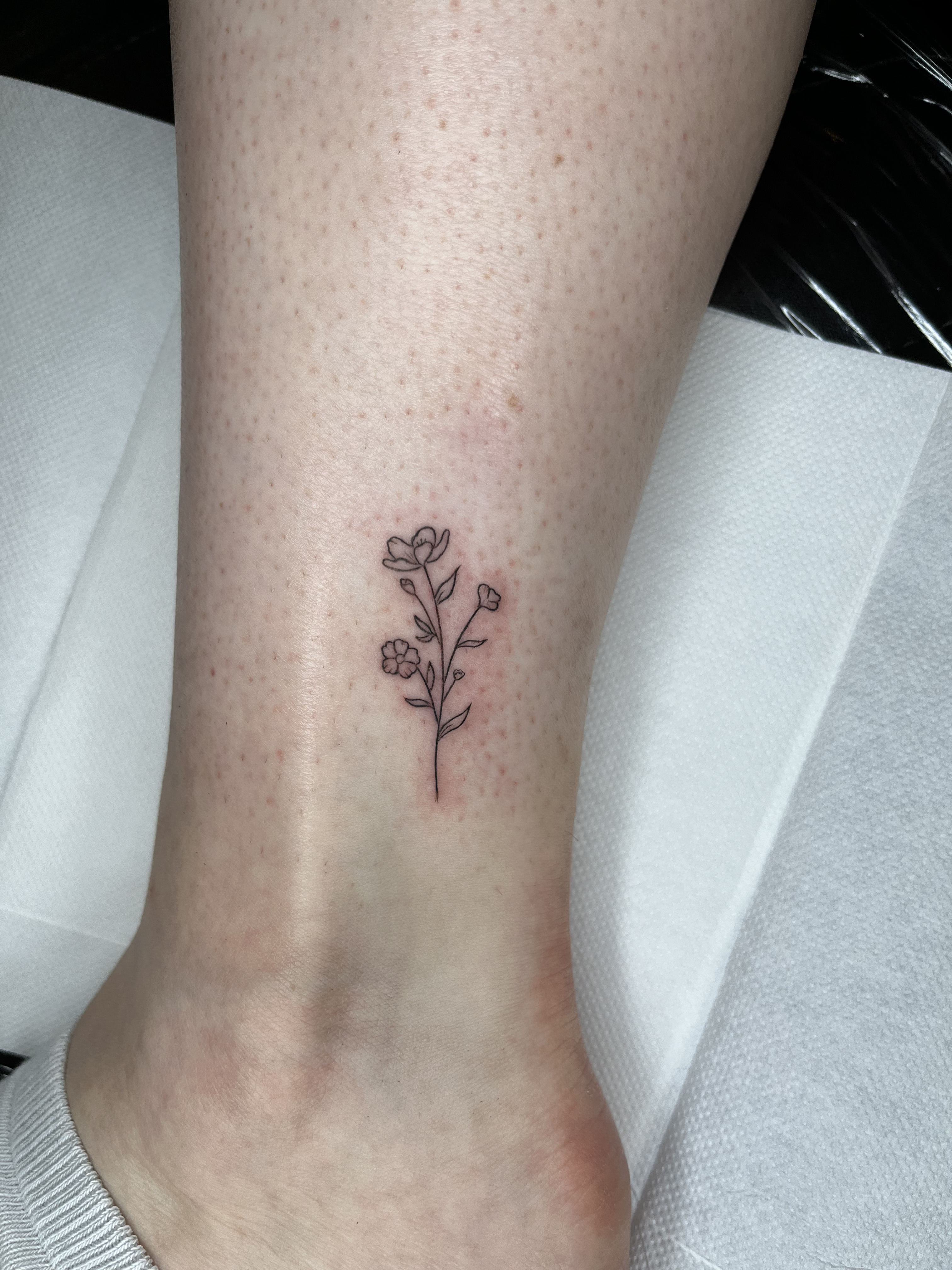 Fine line flower tattoo
